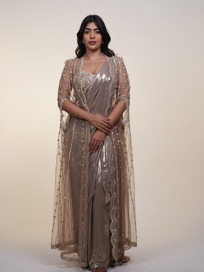 A full-length view of the metallic pre-draped saree with its sheer cape, an elegant and sophisticated choice.