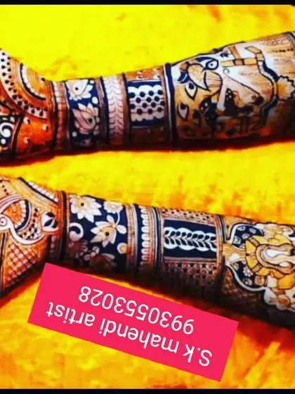 A vibrant design featuring a Ganesha motif on one arm and other traditional symbols. The use of shading and bold lines makes the figures stand out beautifully.