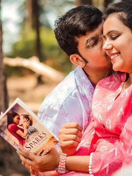 An intimate close-up during the book-themed shoot, capturing a tender moment and shared smiles.