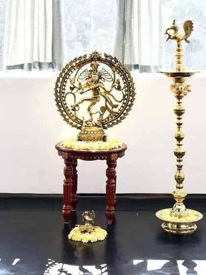 The sacred symbols of dance, the Nataraja and the lamp, stand together in our studio.