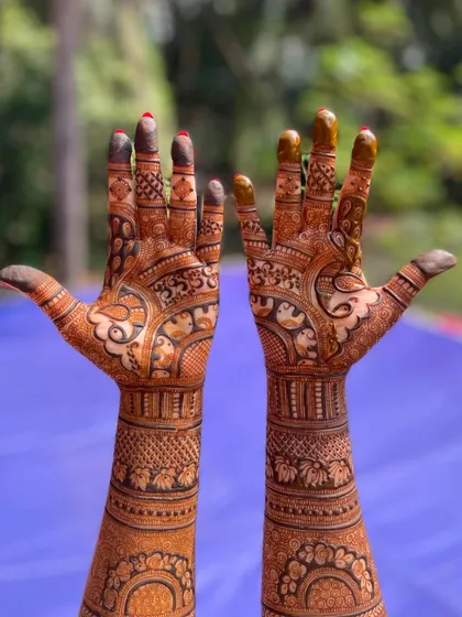 A classic full-arm bridal mehendi that showcases incredible detail from the fingertips to the elbows. I used a combination of fine lines, bold figures, and traditional patterns to create a rich and symmetrical look.