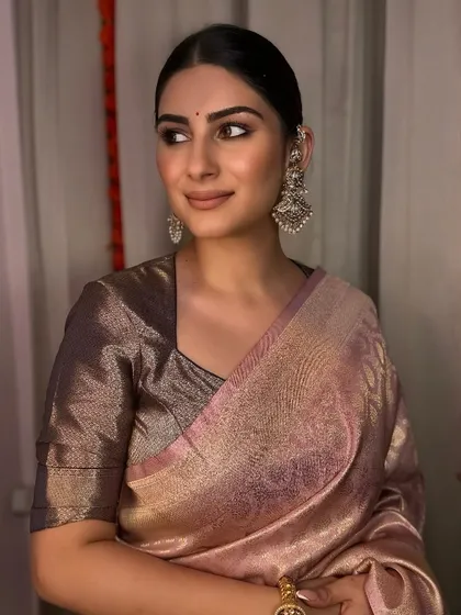 A classic, elegant look perfect for any festive occasion. The clean, winged eyeliner, a simple bindi, and a neat bun create a look that is both traditional and sophisticated.