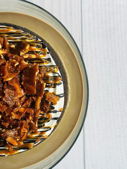 This is my Mocha Caramel Almond Praline Tres Leches. The combination of coffee, gooey caramel, and crunchy almond praline makes every bite a magical experience.