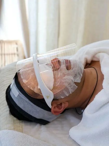 My men's facial treatments go beyond basic cleansing. Here, a client is experiencing an LED light therapy facial, an advanced treatment I use to target specific skin concerns and deliver an instant, noticeable glow.