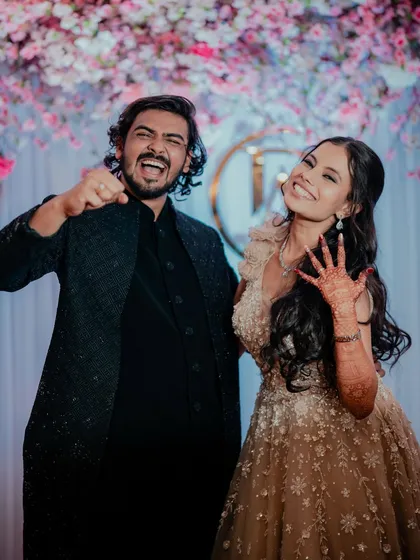 A fun and energetic couple photo from the sangeet night. The bride's makeup is designed to look great both in person and in photos.