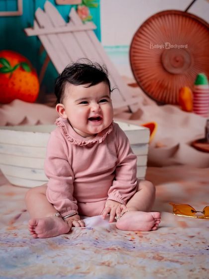 Life’s a beach when you’re this cute. Her happy laugh makes this beach-themed photo so special.