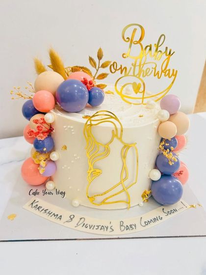Baby on the way and sweetness on the table. An elegant baby shower cake with a modern line-art topper.