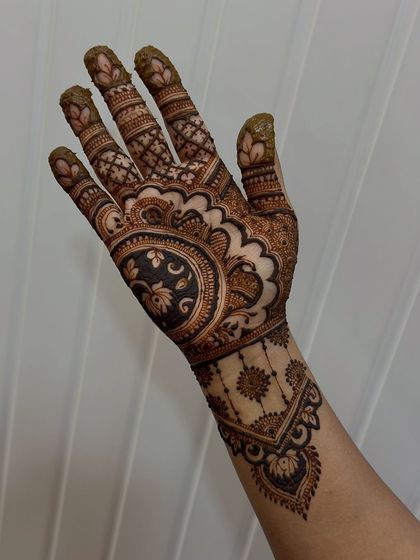 A single hand design created by a student, showcasing their skill with floral and paisley motifs.