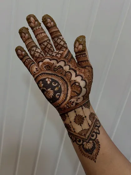 This single-hand design is stunning. The use of dark, filled-in areas creates a beautiful contrast, making the delicate floral work pop. This is an advanced technique my students learn to master.