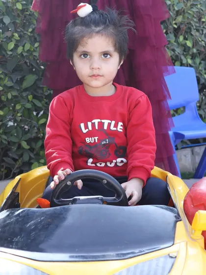 A close-up of a child enjoying the ride-on car, a key feature of my toddler play zone rentals.