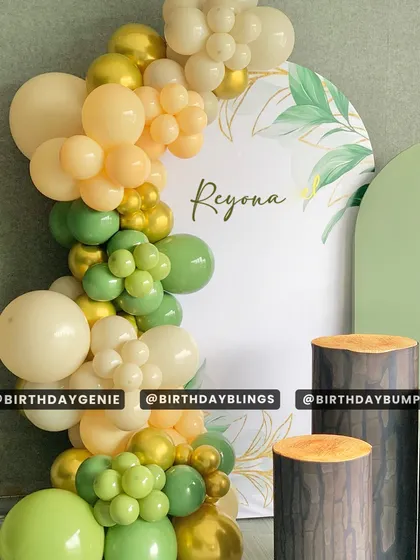 A detail shot of the organic balloon garland from our modern jungle setup, showing the beautiful blend of green, beige, and gold chrome balloons.