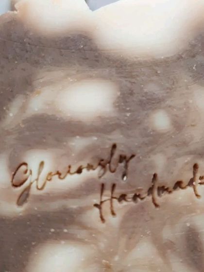 A detailed close-up of the "Gloriously Handmade" stamp on my Neem Cucumber soap. This is my personal seal of quality and care on every bar I make.