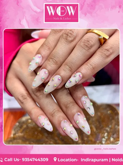 Ready for the spotlight? These long, stiletto nail extensions are adorned with iridescent stones for a look that is pure glamour. We use high-quality materials to ensure your extensions are as strong as they are stunning.