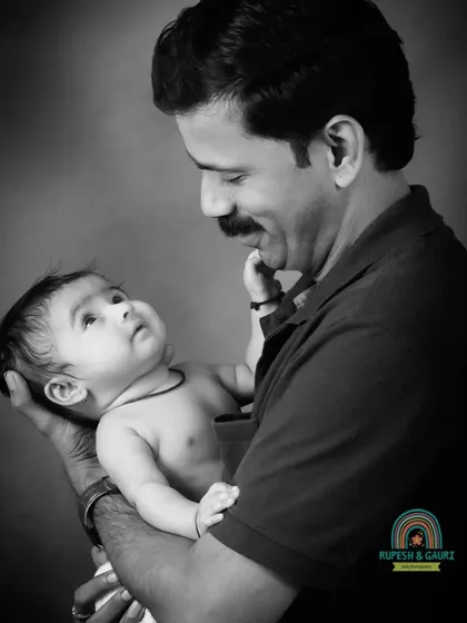 A father's love captured in a timeless black and white portrait. The gentle interaction between a dad and his baby girl is a powerful and emotional moment.