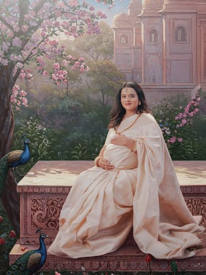 A painterly, Raja Ravi Varma inspired portrait. The mom-to-be is seated gracefully in a garden with peacocks, creating a scene of timeless elegance and tranquility.