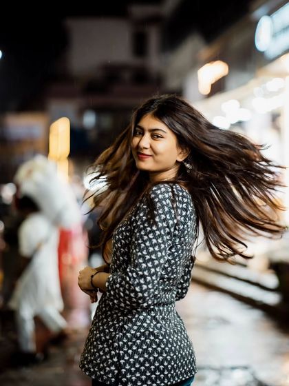 The hair flip adds a fantastic sense of motion and energy to this night portrait, making it dynamic and eye-catching.