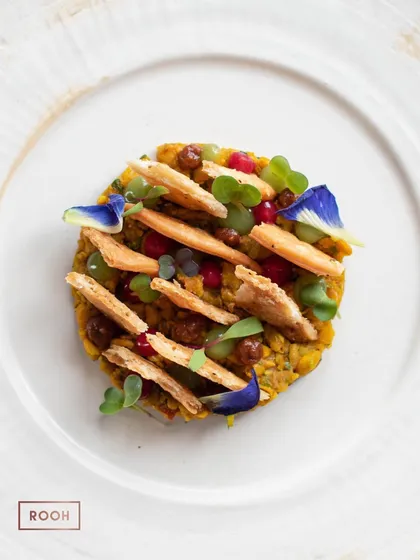 Every dish is a canvas. This is our Khasta Matar Chaat, a beautiful arrangement of textures and colors that reinterprets a classic street food dish with artistic flair and elevated flavors.