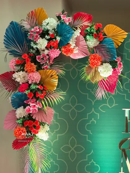 A detailed shot of the floral arrangement on the photo booth, showcasing the variety of colors and textures.