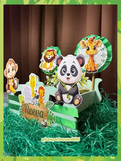 Welcome to the jungle! This fun hamper for Reeva is built into a green MDF jungle cart, surrounded by grass and animal friends.