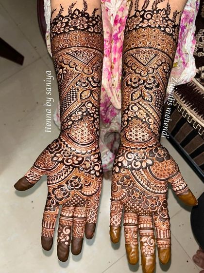 A stunningly detailed design that combines geometric bands with delicate floral and paisley motifs, showing a fusion of styles.