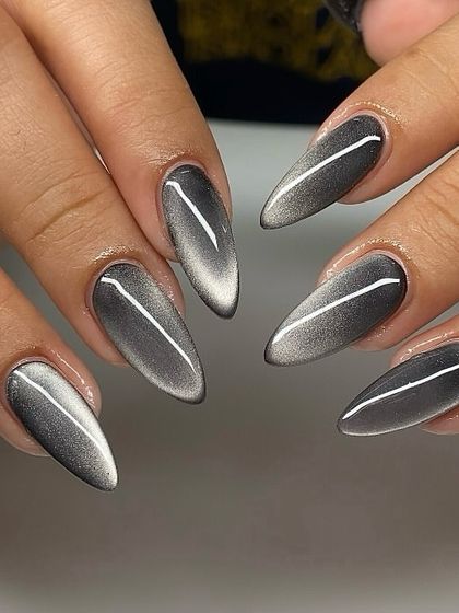 Dripping in metallic magic. This silver cat-eye set on long stiletto nails is sleek, futuristic, and guaranteed to turn heads. The sharp line of light creates a beautiful, elongating effect.