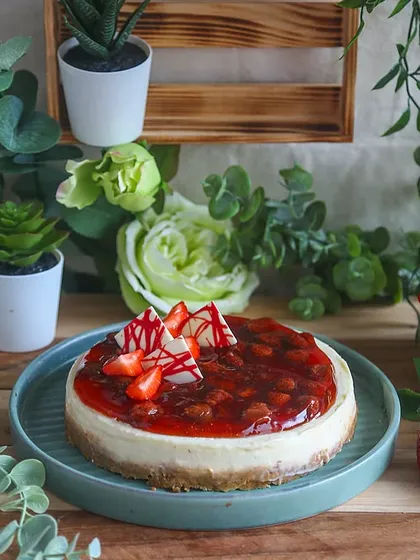 Our eggless baked Strawberry Cheesecake features a classic graham cracker crust and a rich, tangy strawberry compote topping.