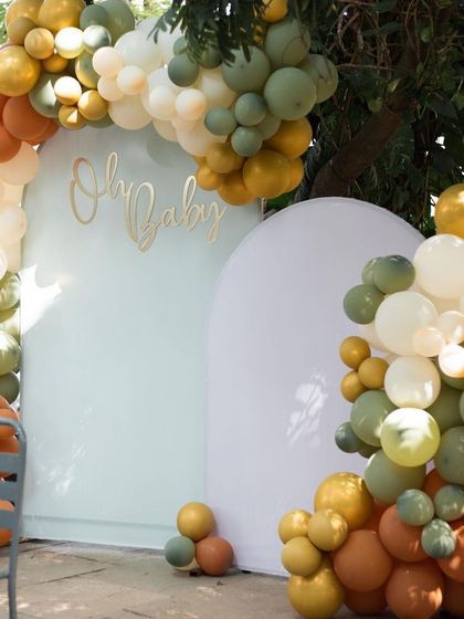 The complete balloon and backdrop installation for the baby shower, showcasing a popular and highly photogenic decor style we can arrange.