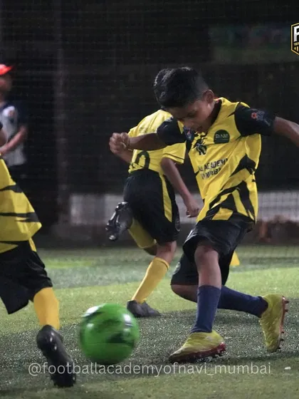 Intense action during a practice match as a player prepares to strike the ball.