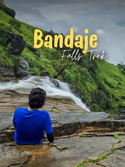 A trekker sits at the top of Bandaje Falls, taking in the incredible view of the water plunging into the valley.