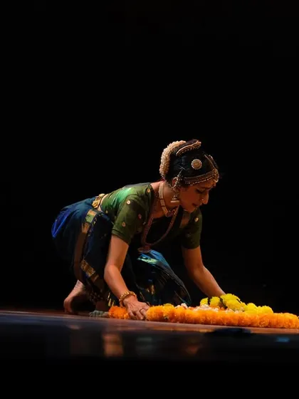 A quiet moment from 'Ananta', where I interact with a floral arrangement on stage. The journey from an idea to a fully staged production is long, but incredibly satisfying.