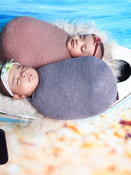 This nautical theme is perfect for twins too. Here, two newborns are swaddled and placed together in the boat for a shared adventure.