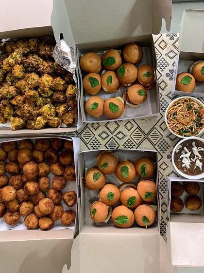 A party order of mini burgers, noodles, and manchurian.