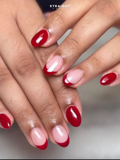 A modern and playful French manicure. This set combines classic red nails with red French tips on a sheer nude base for a fun, mismatched look.