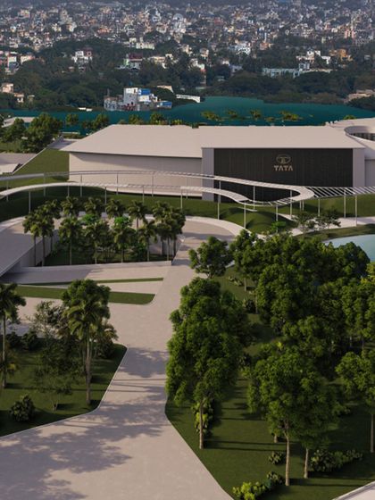 This rendering showcases a large corporate campus with a water feature. The design balances modern architecture with natural landscaping, creating a space that is both productive and pleasant for a major brand like Tata.