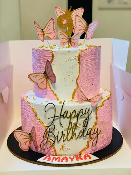 This elegant two-tier butterfly cake is perfect for making any birthday special. With its delicate design and delicious pineapple flavor, it's a beautiful and tasty centerpiece for a girl's birthday party or any celebration needing a touch of grace.