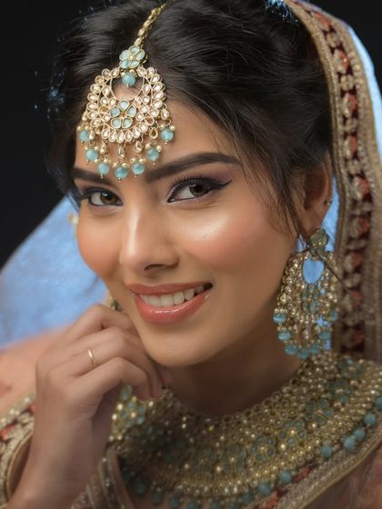 A happy, smiling bride. I teach my students to create makeup that not only looks good but also feels comfortable and allows the bride's personality to shine through.