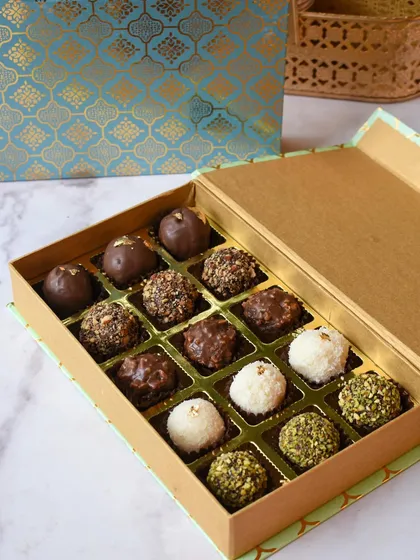 A close-up of my signature chocolate truffles, a bestseller for corporate and festive gifting. This box features a variety of flavors like rich dark chocolate, nutty pistachio, and sweet coconut, each one handcrafted with care.