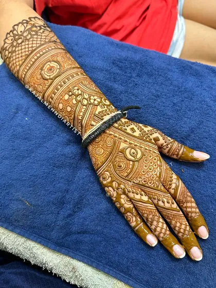 Magic in every stroke. This is a close-up of a full, intricate bridal design showcasing a variety of patterns and textures.