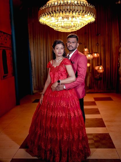 A glamorous portrait in our royal room, with the rich red dress and grand chandelier creating a luxurious feel.