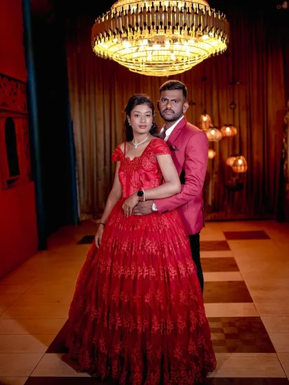 A glamorous portrait in our royal room, with the rich red dress and grand chandelier creating a luxurious feel.