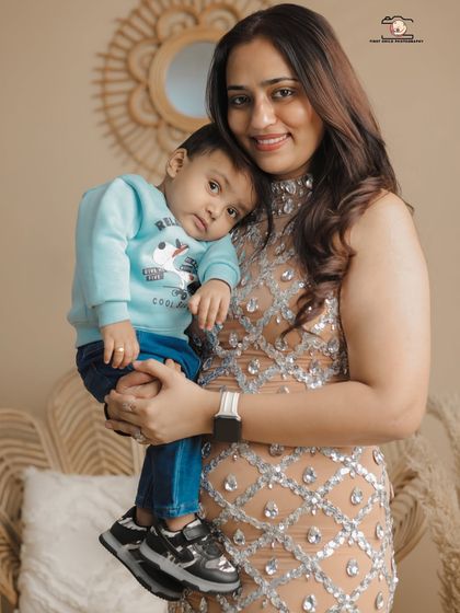 A tender moment between a mother and her son. He rests his head on her shoulder, a simple gesture of comfort and love, captured beautifully during their family studio session.