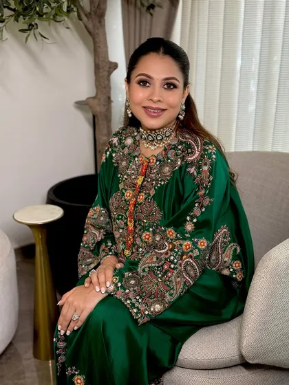 A seated portrait of the mom-to-be, looking serene and beautiful. The makeup enhances her features without being overpowering.