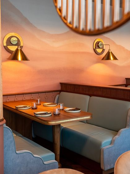 Another perspective of our semi-private booth seating, showcasing the unique wall art and custom lighting that makes each corner of our restaurant photogenic and memorable for your guests.