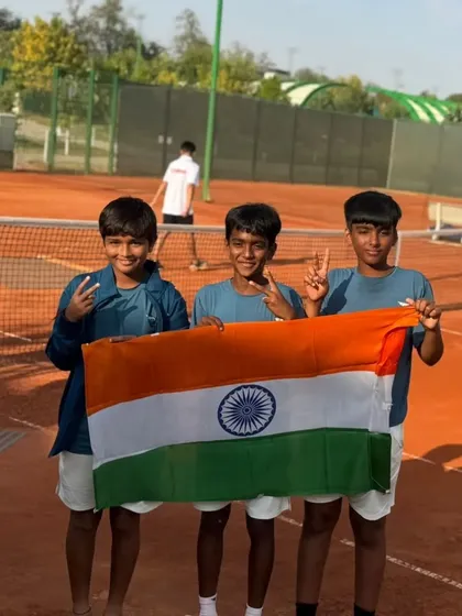 The boys of Team India U-12 holding the flag together, a symbol of unity and national pride.