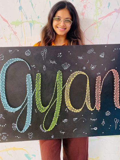 A custom string art name board being created for a special gift. We love helping people make personalized and meaningful art.