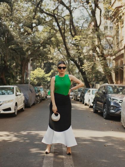 A full-length shot that uses the lines of the street and parked cars to create a classic, urban fashion photograph.