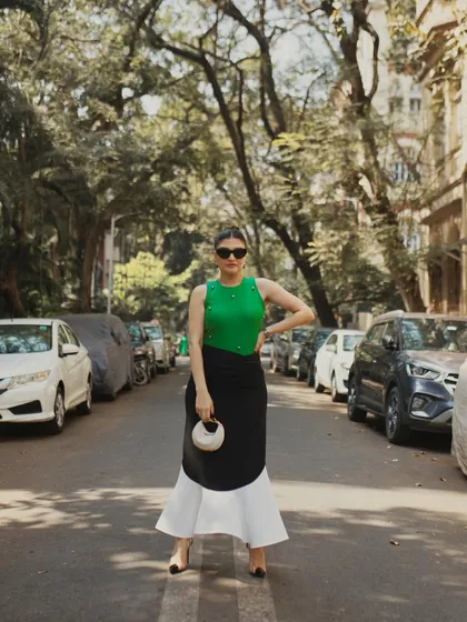 A full-length shot that uses the lines of the street and parked cars to create a classic, urban fashion photograph.
