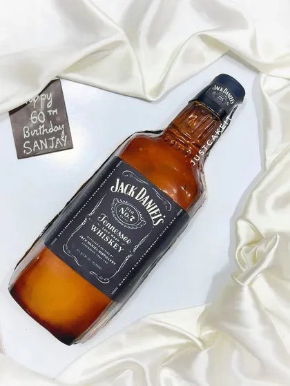 A zero-fondant Jack Daniel's bottle cake, carved and airbrushed to look like the real thing. This was a chocolate truffle cake for a 60th birthday celebration.