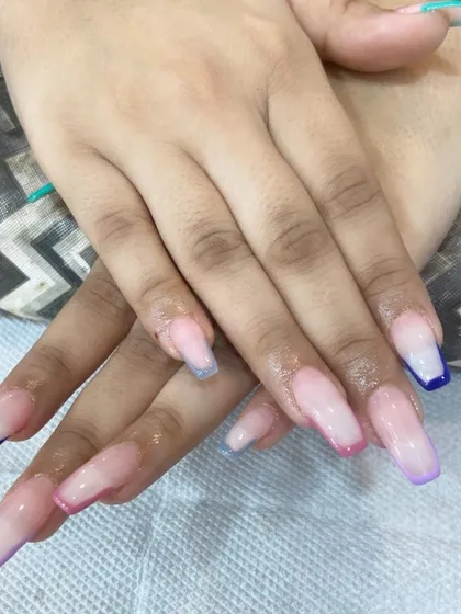 Here is another angle of the multi-color French tip extensions. This style is perfect for anyone who wants a subtle design that still shows off a bit of color and personality.
