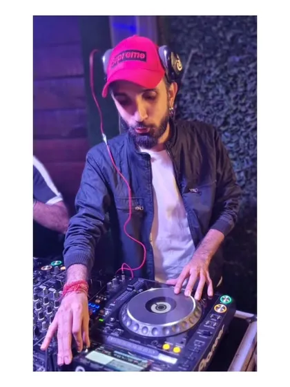 In the mix with my headphones on, fully concentrated on the transition between tracks. This is a key part of the seamless DJ experience I provide.